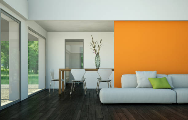 istock Modern loft interior design with sofa in front of orange wall and dining table 1000992690
