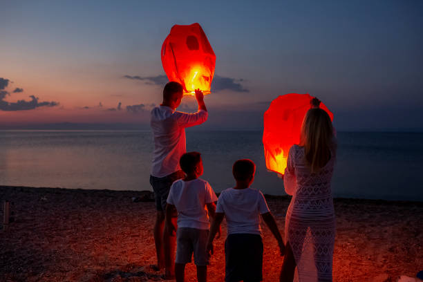 istock Releasing paper lanterns by the sea 1000994252