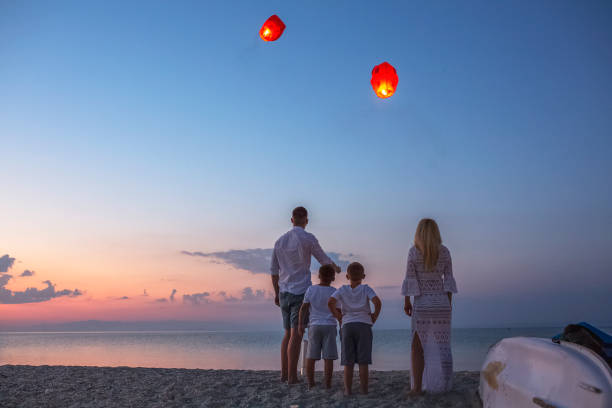 istock Releasing paper lanterns by the sea 1000994608