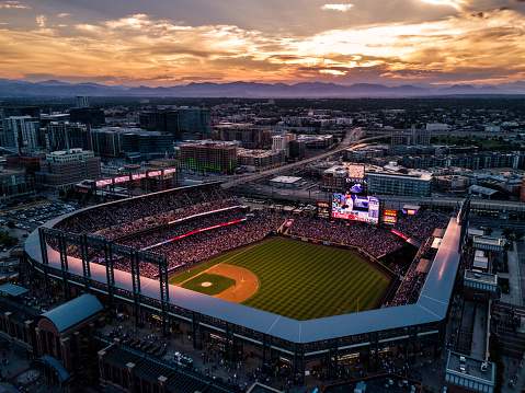 Denver, Colorado - 7/14/18 - A beautiful sunset over the Colorado Rockies baseball stadium with the Colorado Rocky Mountains on the horizon.