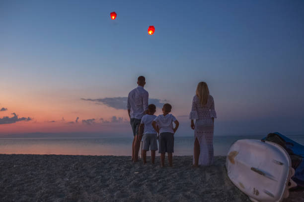 istock Releasing paper lanterns by the sea 1000997082
