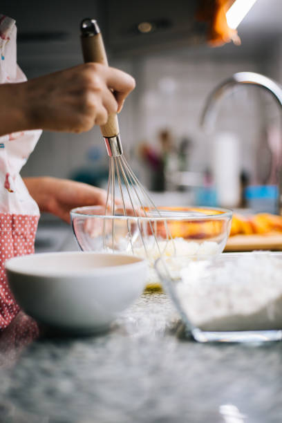 istock Young woman holding bowl with dough and whisk 1000997474