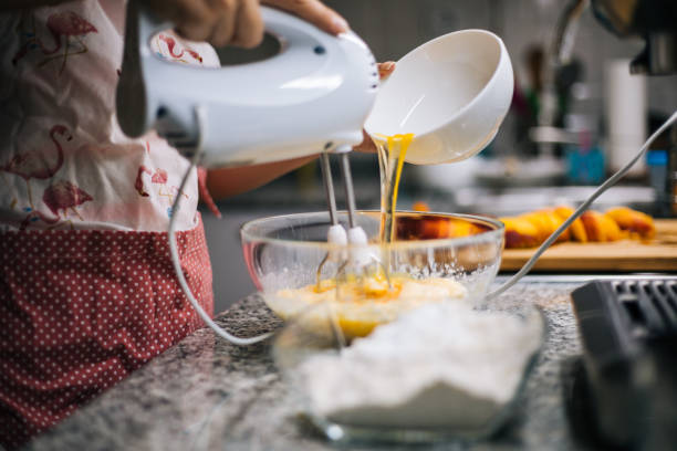 istock Young woman holding bowl with dough and whisk 1001000454
