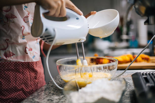 istock Young woman holding bowl with dough and whisk 1001000458
