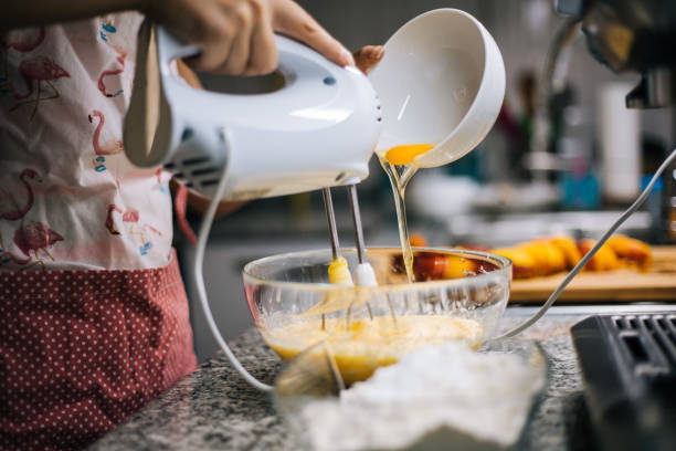 istock Young woman holding bowl with dough and whisk 1001000922