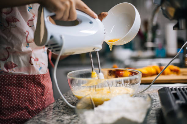 istock Young woman holding bowl with dough and whisk 1001001652