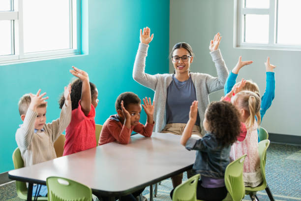 istock Multi-ethnic preschool teacher and students in classroom 1001002350