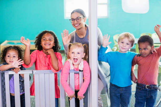 istock Teacher and preschool students smiling, waving 1001007800