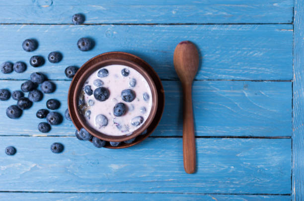 istock Dessert of blueberries. Blueberries with cream. 1001008000
