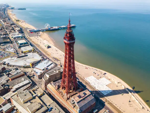 An aerial view of the Blackpool Tower with the Central pier in the background located in Blackpool, UK