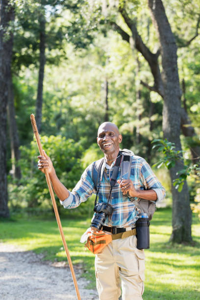 istock Senior African-American man hiking, with camera 1001012222