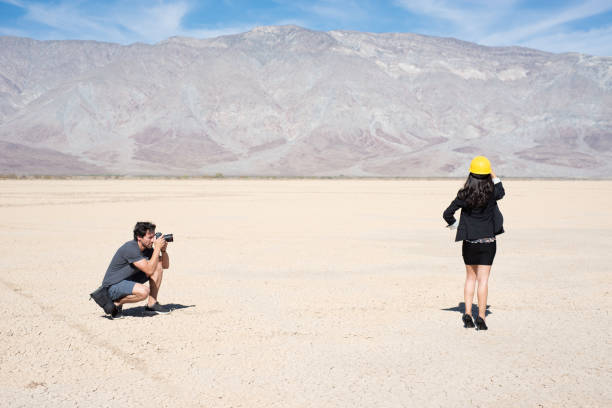 istock Photographer Shooting A Model In The Desert 1001025928