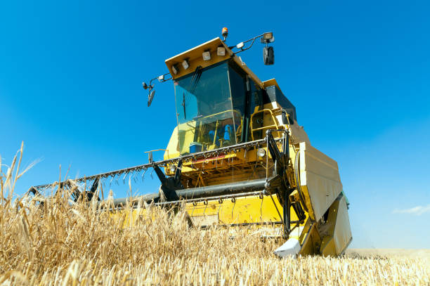 istock Harvester performing mowing tasks in the field 1001032124