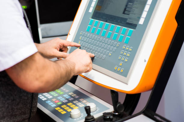 istock Man working on a keyboard of a console for controlling an industrial machine. Man's hands on a control panel 1001099822