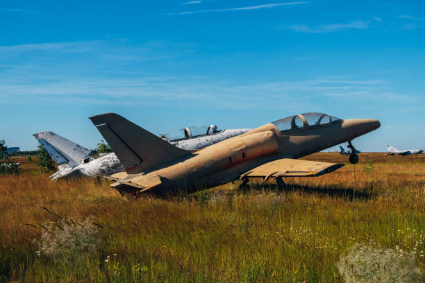 istock Abandoned broken old military fighter airplanes on grassy ground 1001102608
