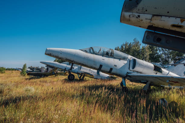istock Abandoned broken old military fighter airplanes on grassy ground 1001102650