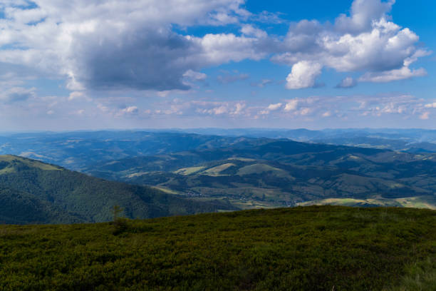 istock A blue, slightly cloudy sky and beautiful, green mountains with a little haze over them 1001102724