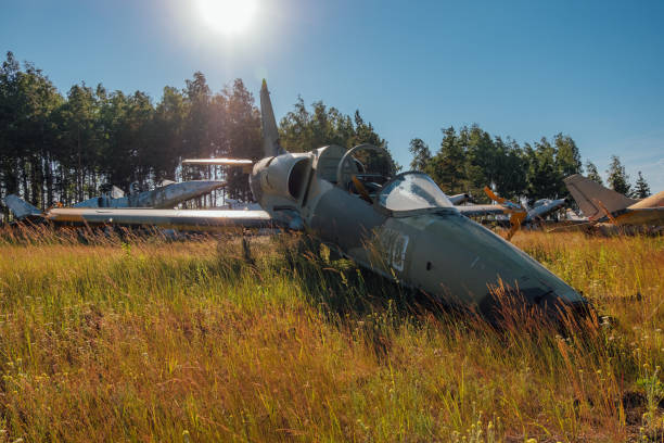 istock Abandoned broken old military fighter airplanes on grassy ground 1001102898