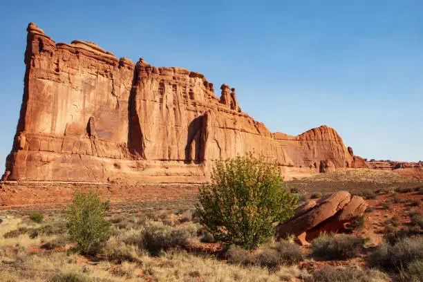 An east side view of the iconic red slickrock strata found along the Park Avenue Trail in Arches National Park