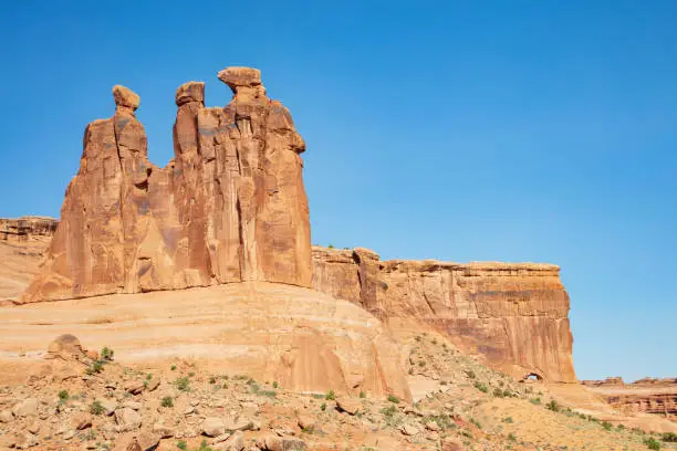 The famous red slickrock 3 Gossips formation found along the Park Avenue Trail in Arches National Park