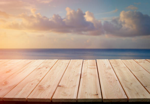 istock Wooden table with sea and sky behind 1001120812