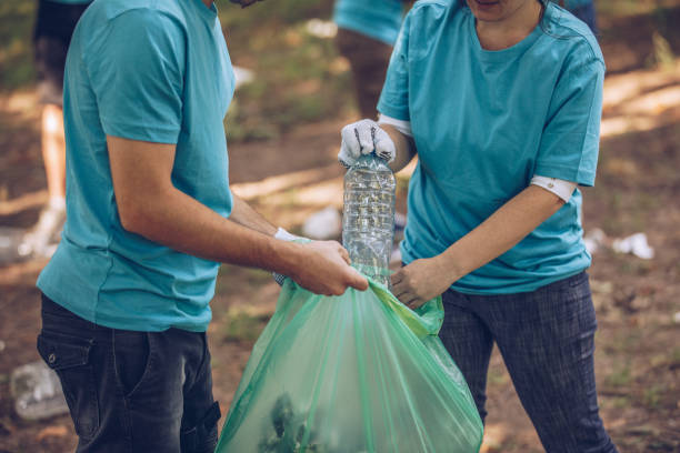 istock Volunteers picking up trash in park 1001133262