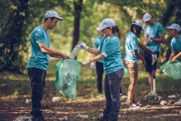istock Volunteers collecting garbage in park 1001133444