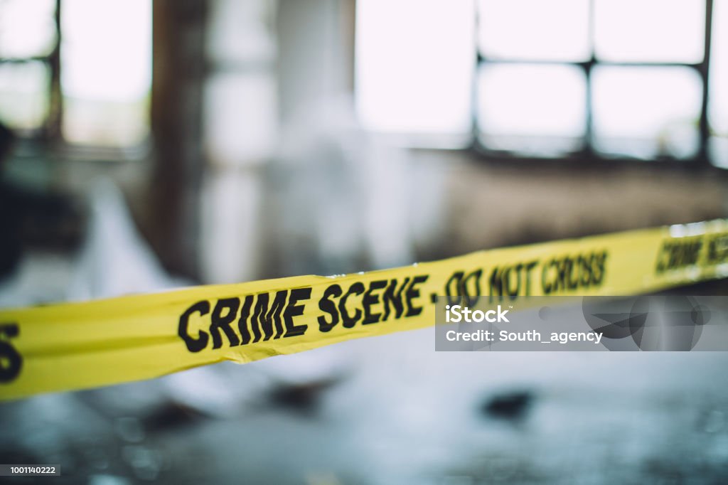 Cordon Tape On A Crime Scene Detectives and forensics on murder crime scene collecting evidence Murder Stock Photo