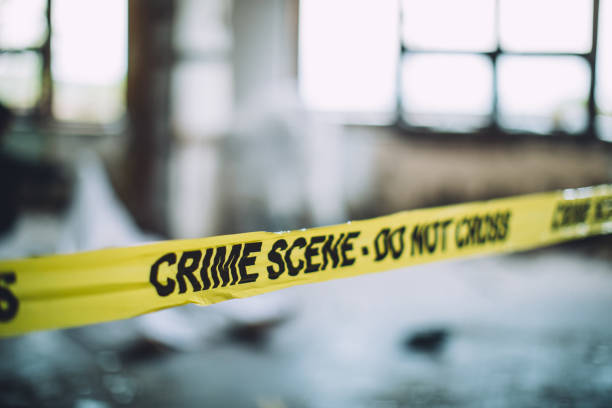 Cordon Tape On A Crime Scene Detectives and forensics on murder crime scene collecting evidence killing photos stock pictures, royalty-free photos & images