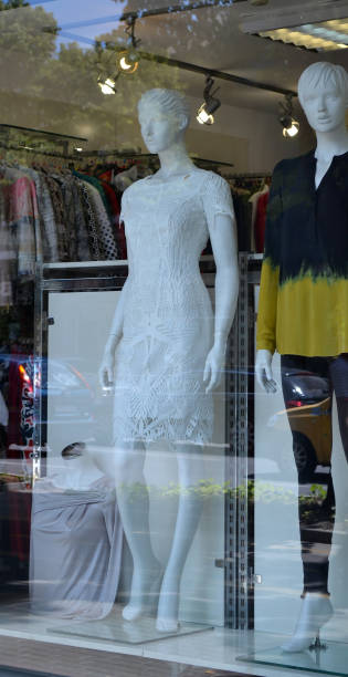 istock An elegant openwork white dress is on a white mannequin in a shop window 1001150856