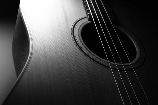 Acoustic guitar close-up. Focus on the fretboard. Subjects of music playing
