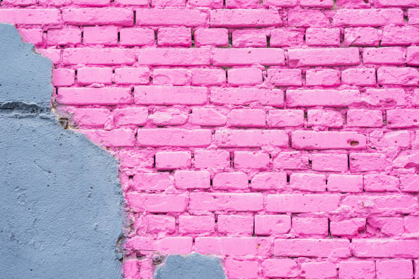 Exposed brick on damaged wall, abstract background from concrete and painted pink brick wall texture urban background, copy space