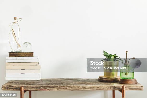 Stylish And Modern Decor With Wooden Console Books Plants And Accessories Copy Space For Inscription Stock Photo - Download Image Now