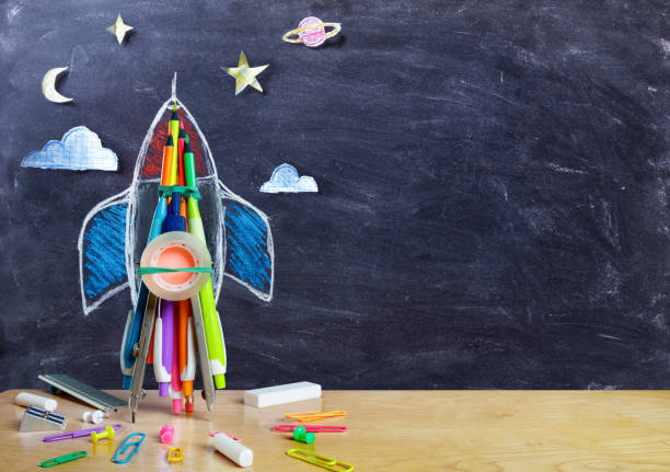 Startup - Rocket Drawing With School Supplies On Table