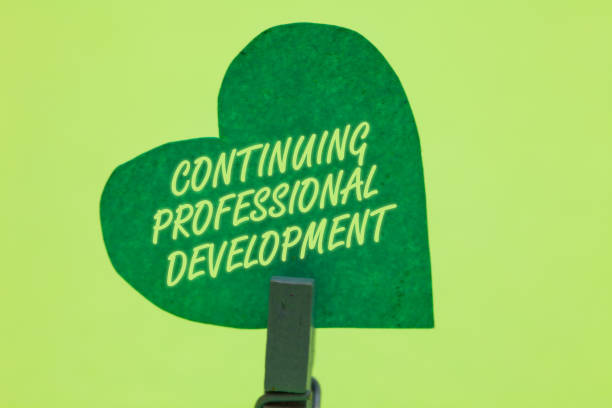 Conceptual hand writing showing Continuing Professional Development. Business photo showcasing tracking and documenting knowledge Clothespin holding green paper heart romantic message ideas.