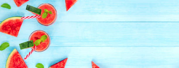 Watermelon juice smoothies in the glasses on light blue wood background
