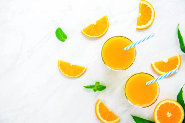 istock Refreshing drinks for summer, orange juice with ice cubes in the glasses 1001168166