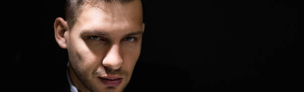 istock Tricky sly man face in dark room 1001168242
