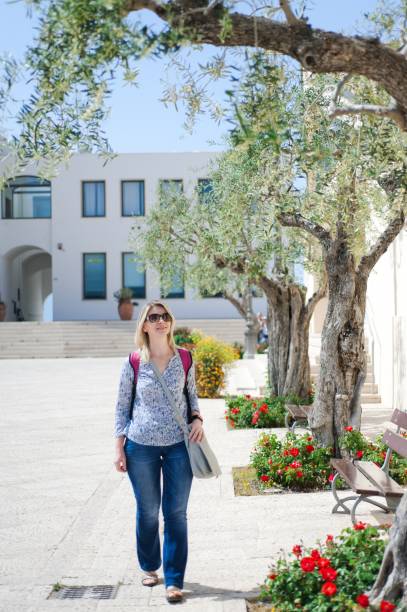 istock A white young tourist with a backpack is walking along the centr 1001176846