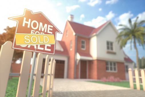 Home for sale, real estate sign in front of beautiful house with beam of sunlight coming from the background. Home business and finance concept.