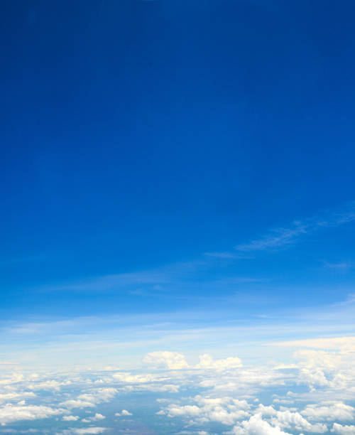 istock Beautiful view of blue sky above the white clouds from airplane window 1001196476
