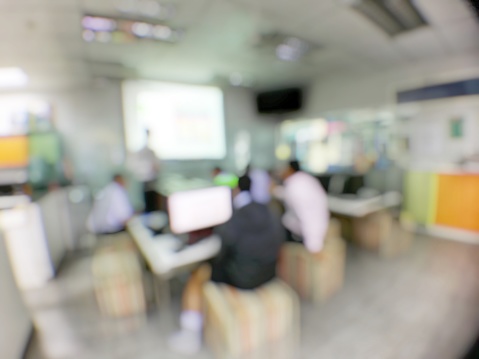 Blurred image of students are learning and sitting at desk using computer lap together and lecture in classroom for study and workshop in computers room at school. education or training concept