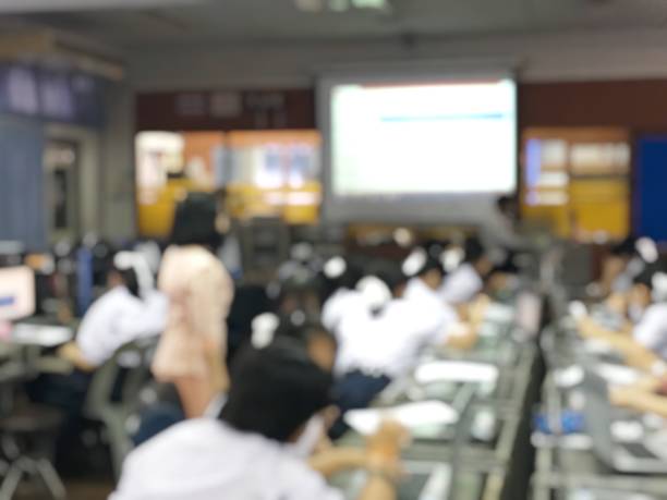 istock Blurred image of group of students are learning and lecture and using computer together in classroom for study and workshop in computers room at school. education technology or training concept. 1001207592