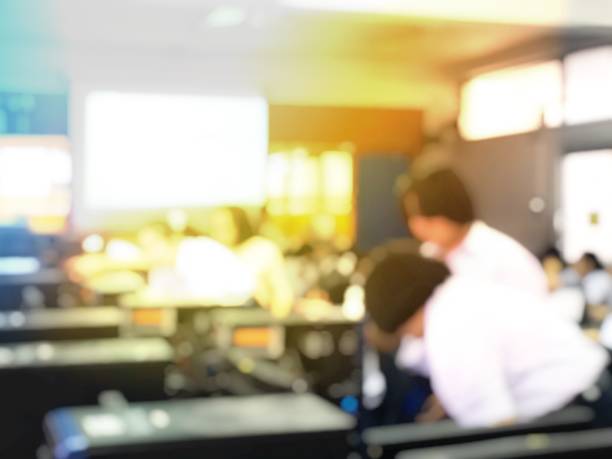 istock Blurred image of group of students are learning and lecture and using computer together in classroom for study and workshop in computers room at school. education technology or training concept. 1001207628
