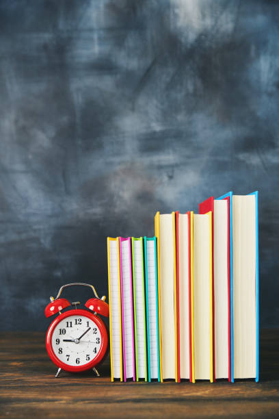 istock Back to school background with books and clock 1001225122