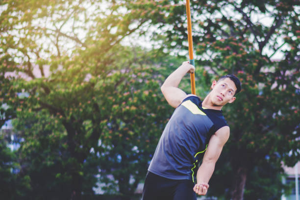 istock sportsman warming up and practicing javelin throw in yard 1001233602