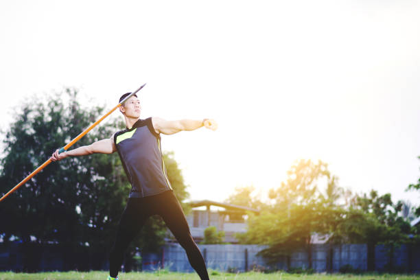 istock sportsman warming up and practicing javelin throw in yard 1001240102