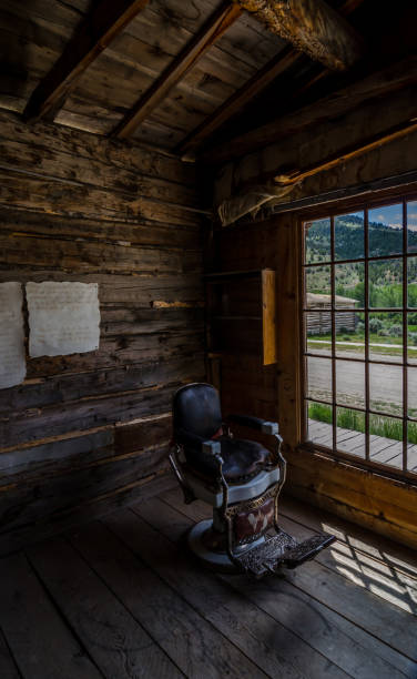 Old barber chair in Bannack State Park Abandoned barber chair in ghost town of Bannack, Montana. covered wagon horse cart snow winter stock pictures, royalty-free photos & images