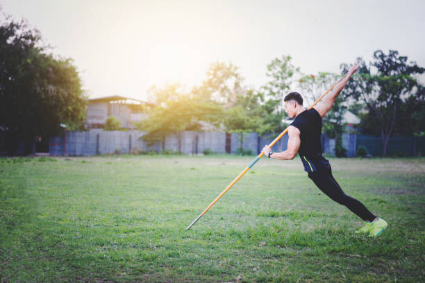 istock sportsman warming up and practicing javelin throw in yard 1001261172