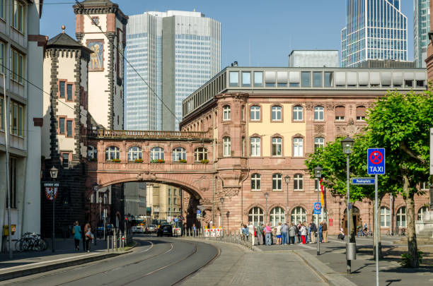 Old buildings in Frankfurt, Germany with new modern skyscrappers in background, During early summer morning.
